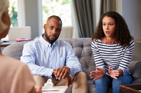 African-American couple on sofa working through divorce
